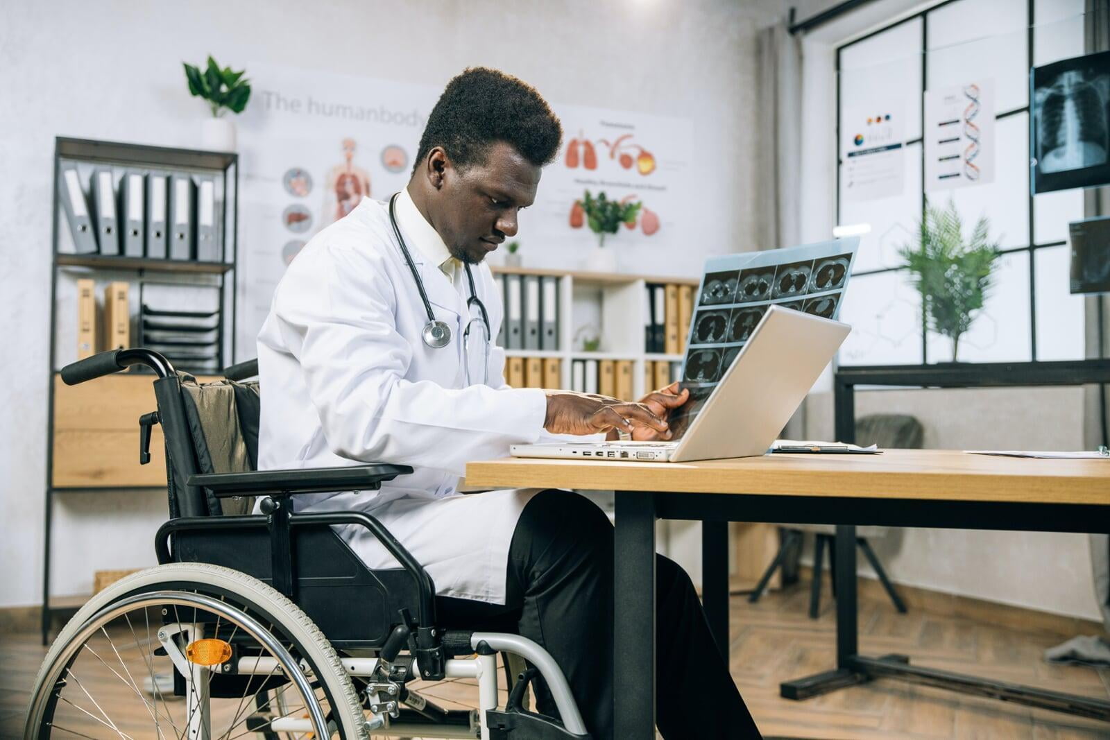 A man in a wheelchair works in a lab office