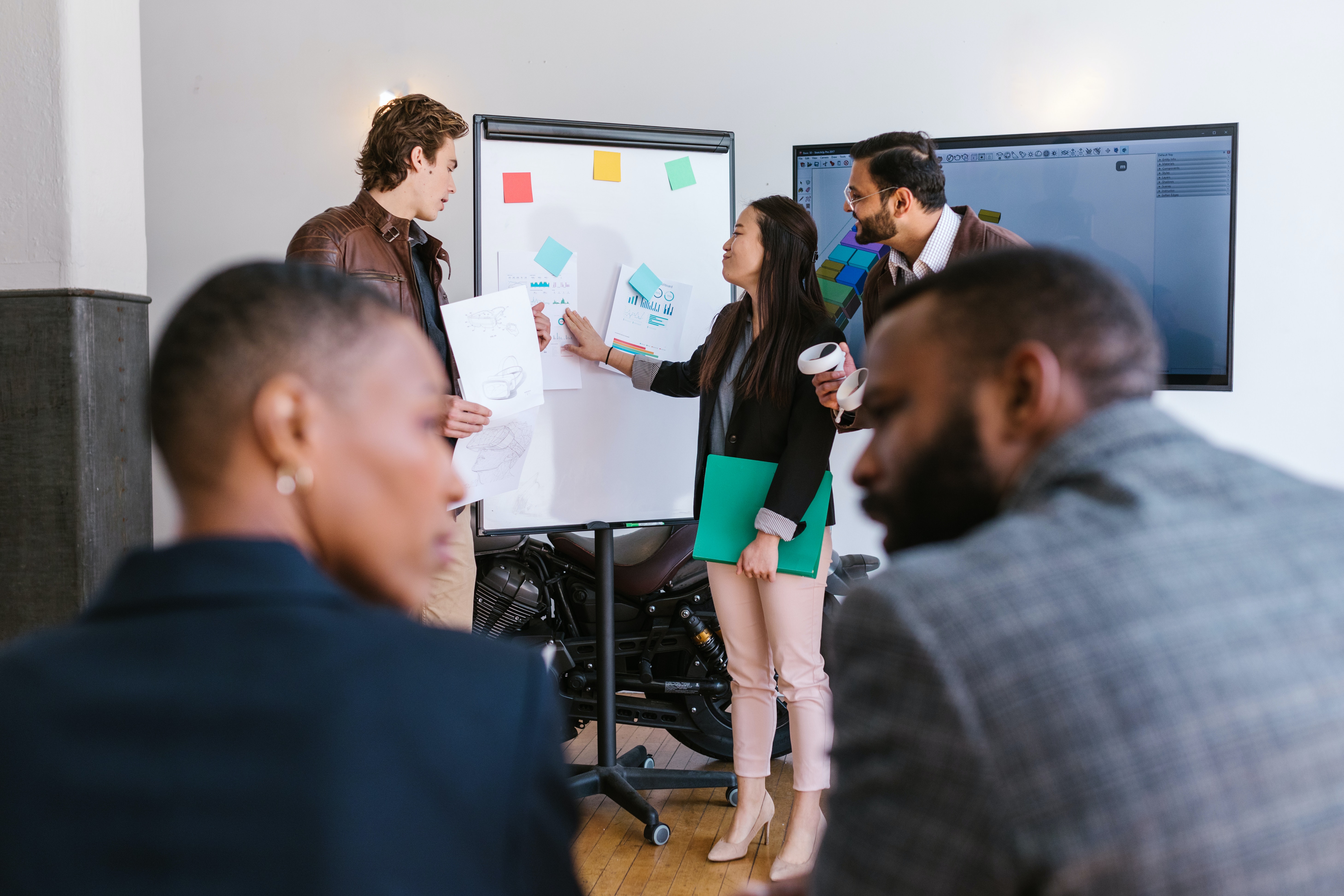 A group of people working together using a whiteboard