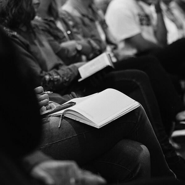 students receiving a lecture from professor in auditorium