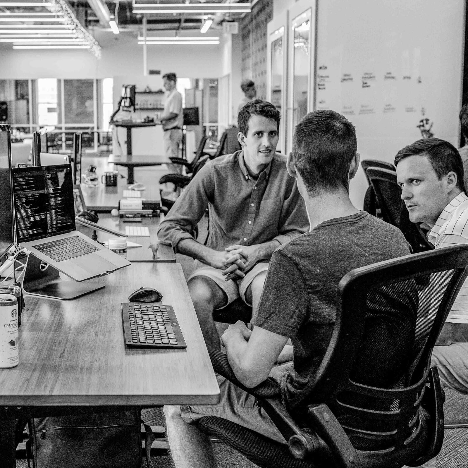 students discussing around desk