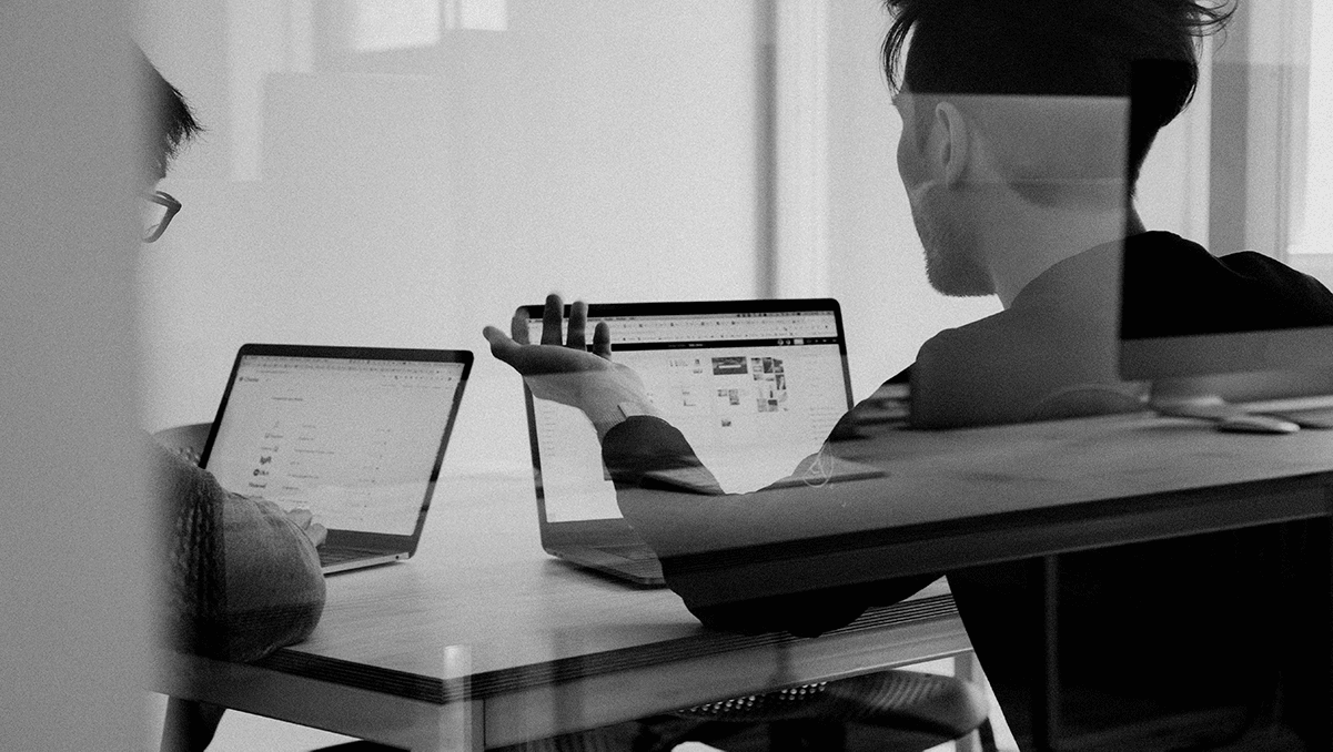 students at table on their laptops